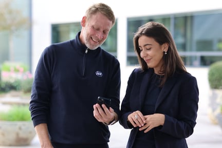 Placemaker and manager looking at MyWork@ISS on phone